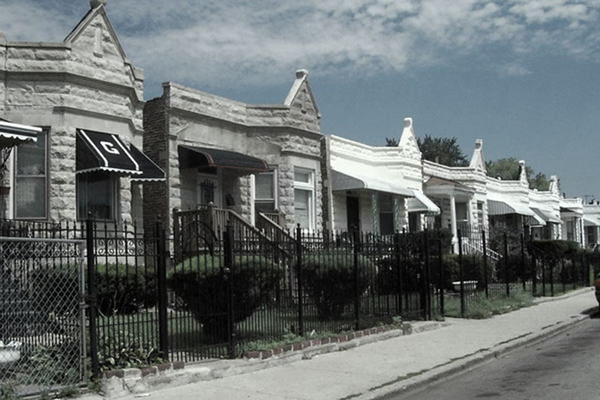 Figure 3: Row houses in South Lawndale, typical of many of the highdensity
community areas on the South Side and West Side of the city. The
flat residential structures of this community area have similar population
density rates to the vertical residential environments of the Near North,
though the built environment is vastly different. Photo by author, 2011.