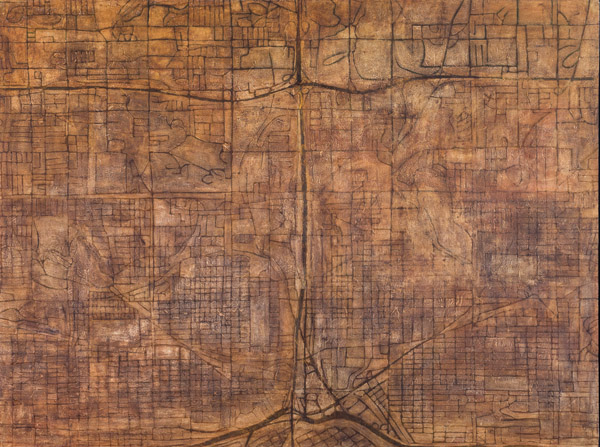 An image of a brown map with black road lines atop. The brown colors of the map vary subtly and organically. Photo by Charles P. Rader.